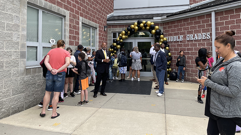 Community members waiting to greet students.