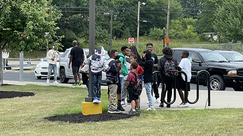 Students visiting together as they wait to go into the school.