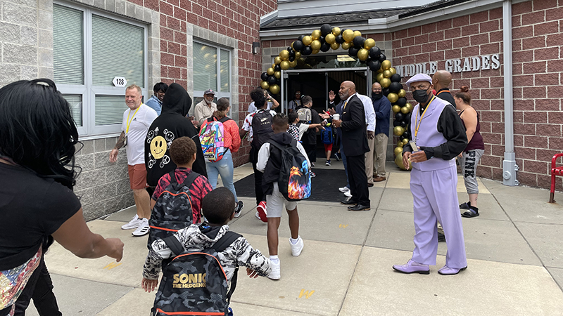 students greeted as they enter the building.