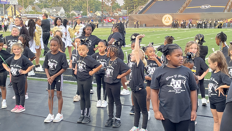 Standing in front of the audience ready to perform.