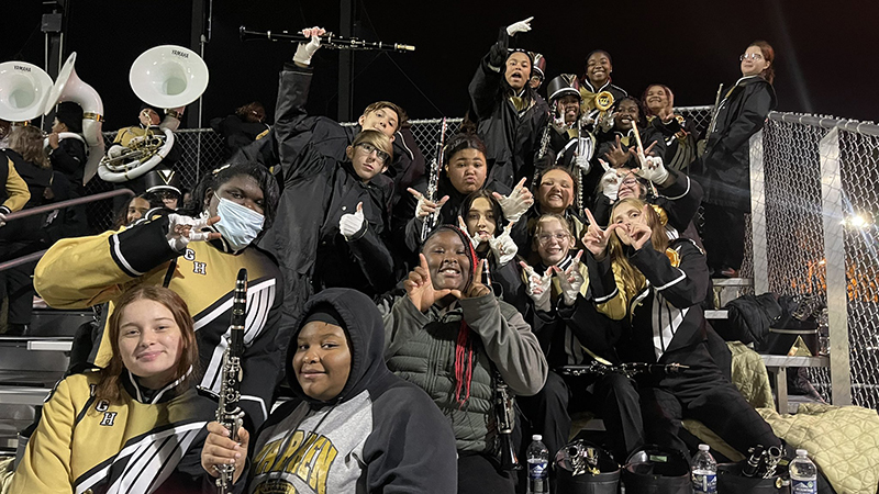 Jefferson band students hanging out with Harding band members in the stands.