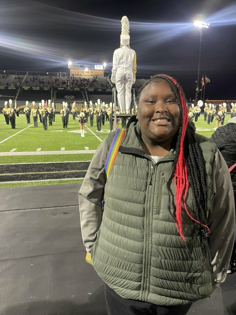 A Jefferson eighth grade student ready to watch Harding marching band on the field.