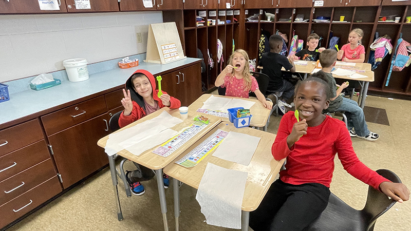 First graders sitting at their desks ready for their treat.