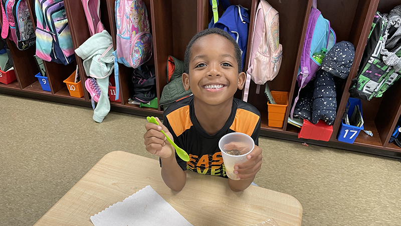 A first grader enjoys his treat.