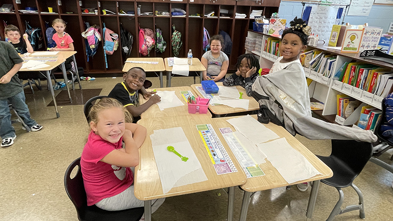 Students sit and visit with each other as they wait for their treat