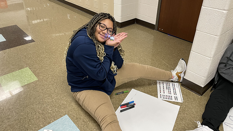 A student shows her robot.