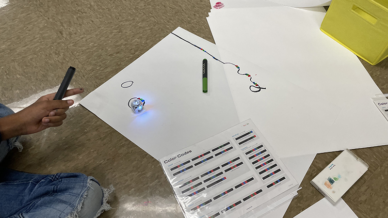 A robot and the coding sheet students use for their assignment.