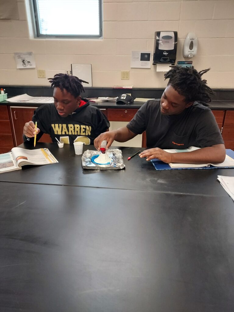 A pair of eighth graders work together on their experiment.