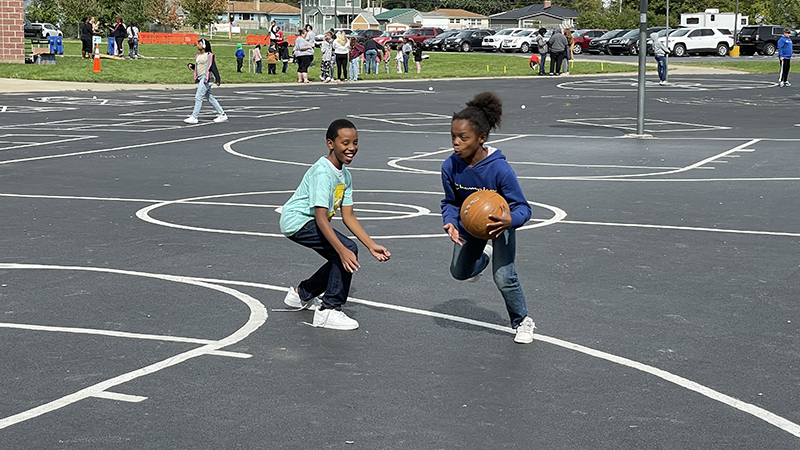 Students having fun playing basketball.