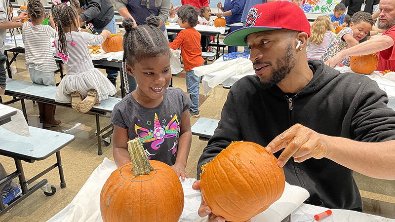 A helper shows the inside of the pumpkin.