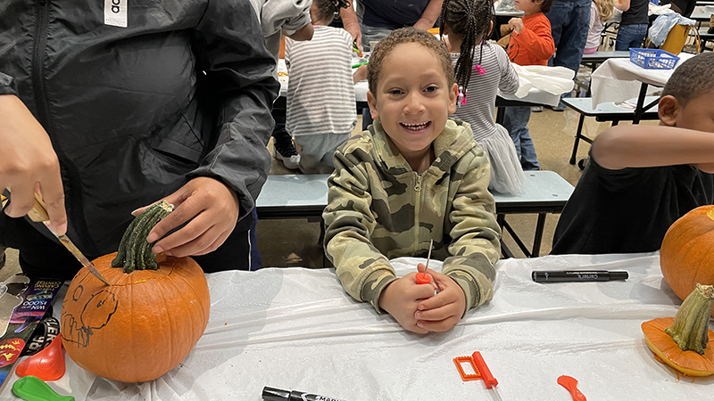 A student ready to carve his pumpkin.