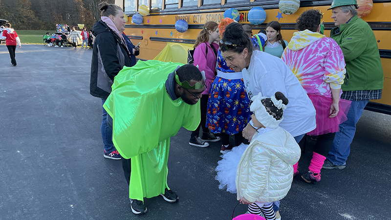 A Warren bus driver talking to a student.