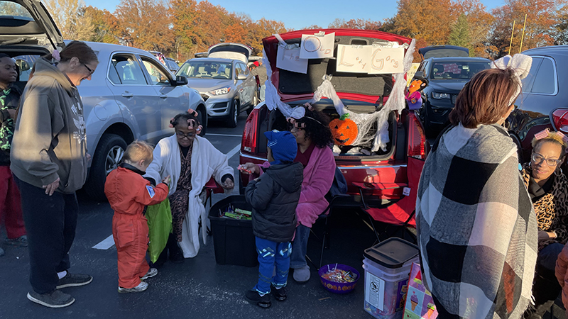 Community members helping to pass out candy.