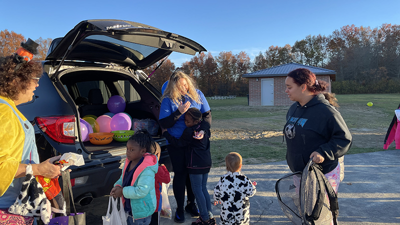 Our phys. ed teacher passing out candy to families.