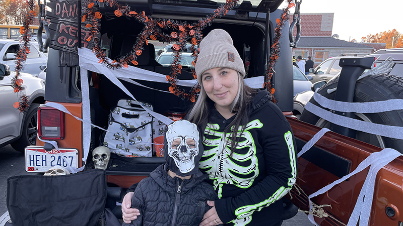 A teacher and her son enjoying the trunk or treat together.