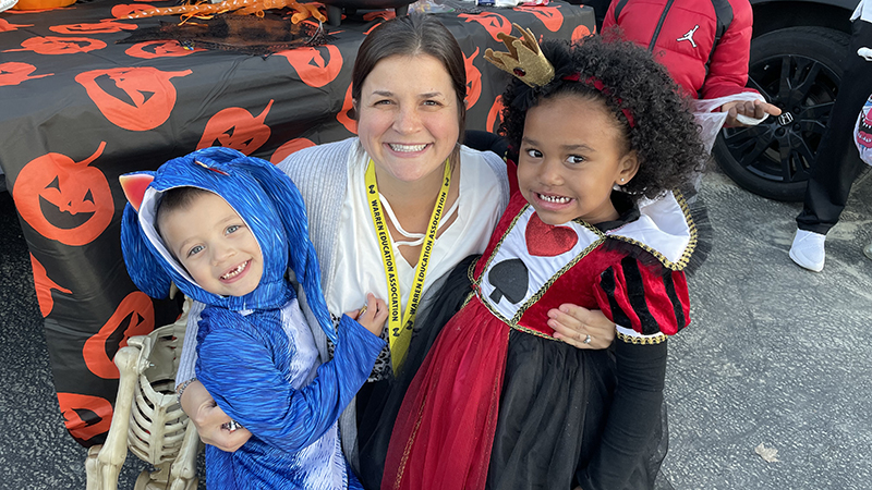 Mrs. Rhodes with a couple trunk or treaters.