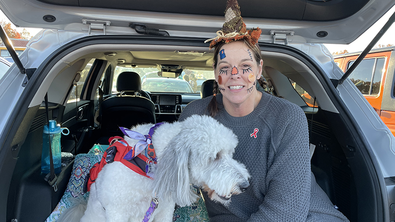 Mrs. Goodyear and her therapy dog Sophie helping at trunk or treat.