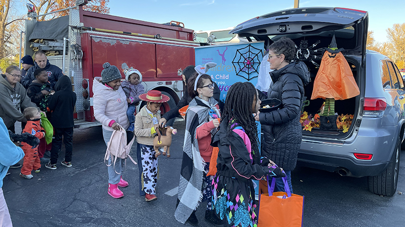 Students going to each vehicle for trunk or treat