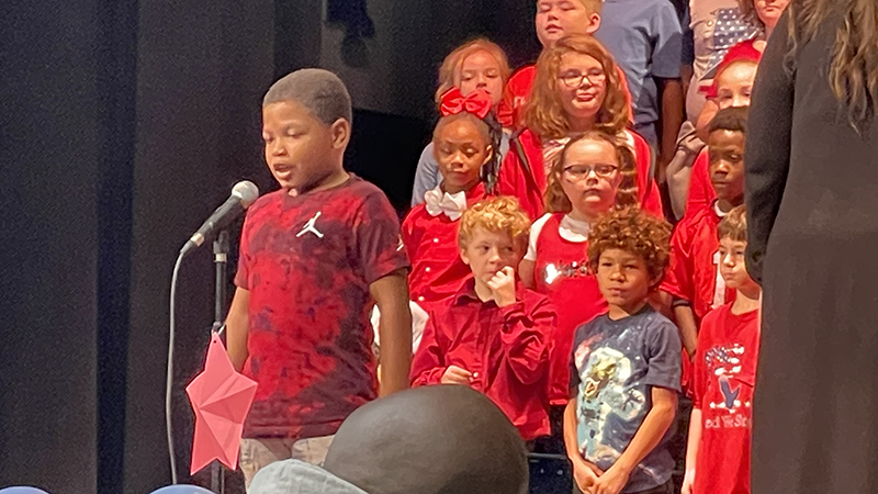 A student recites a line to poem he has memorized.