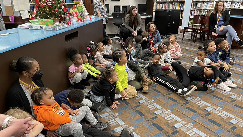 Students and teachers watch the magic show.