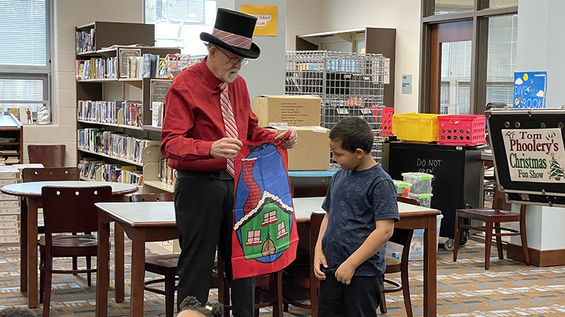 A student volunteers to help with a magic trick.