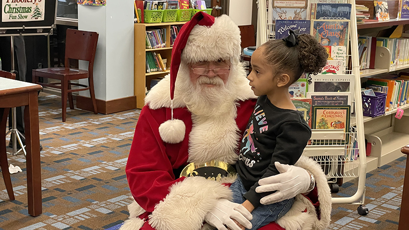 A student tells Santa what he wants for Christmas.