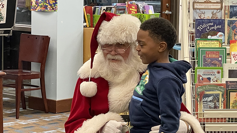 A student tells Santa what he wants for Christmas.
