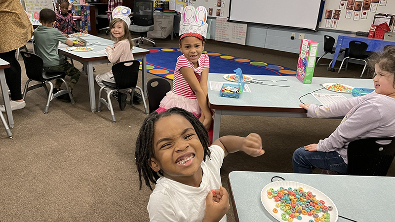 kindergarten students count out one hundred fruit loops for their activity.