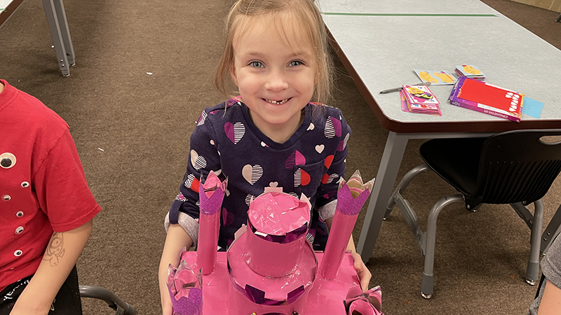 A student shows her Valentine box.