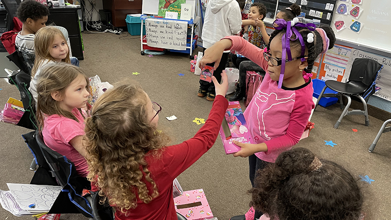 A student passes out Valentines.