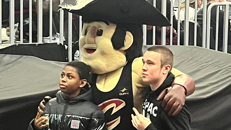 Students get their picture taken with the Cavs mascot.