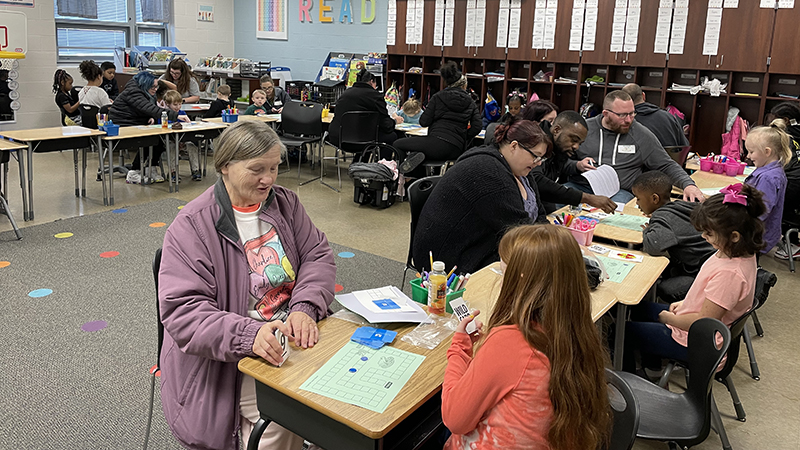 A student and her guest play their math game together.