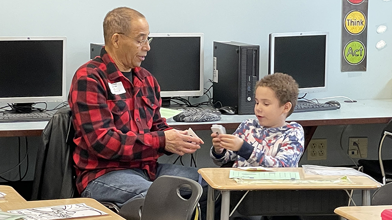 A first grader explains the game cards.