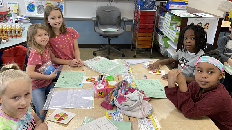 A group of first graders listen for directions.