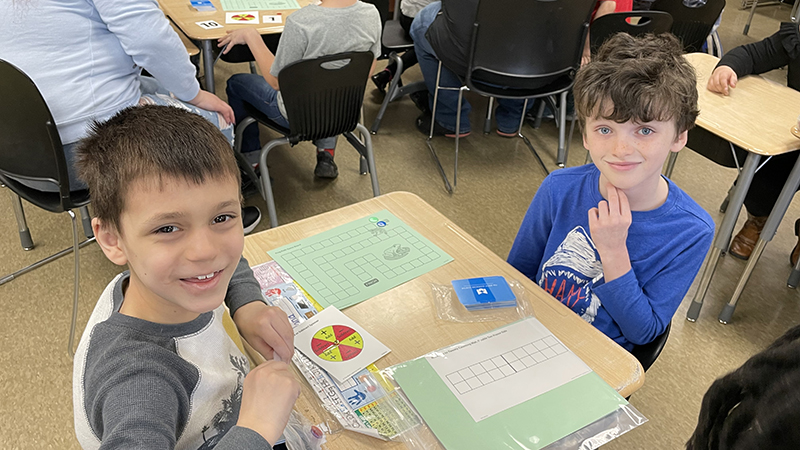 Two friends playing their math game.