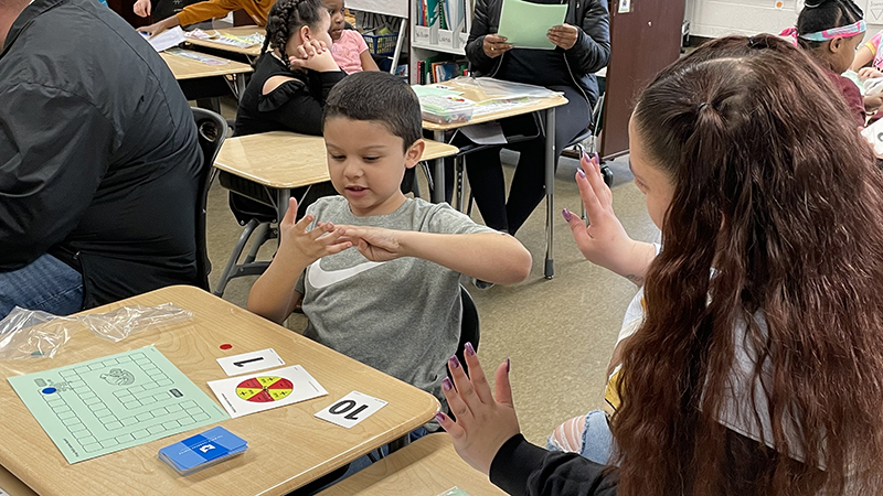 A first grader finding the answer with his guest.