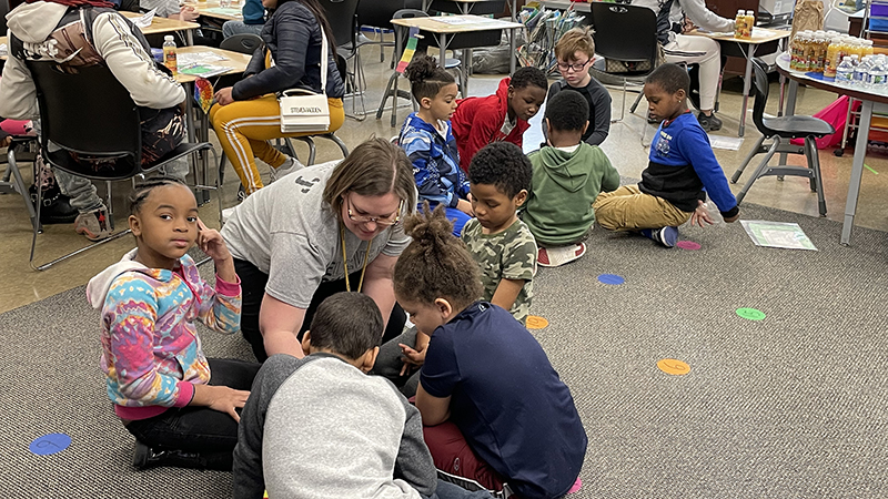 Mrs. Lines explains the game to her students.