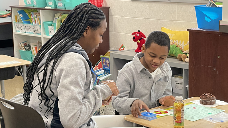 A first grader and his guest play their game.