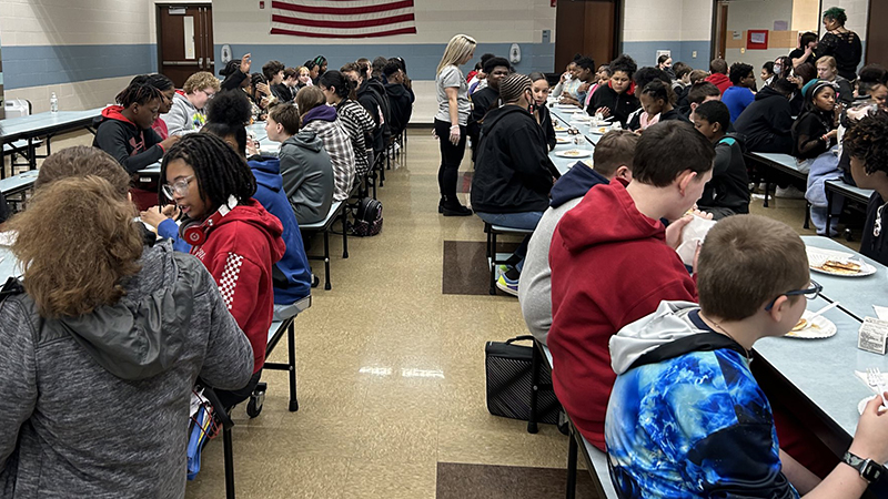 Middle school students enjoying their pancakes.