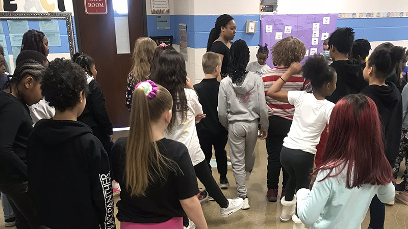 Students try a dance together.