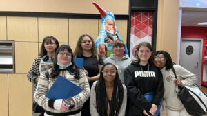 Students standing in front of YSU penguin