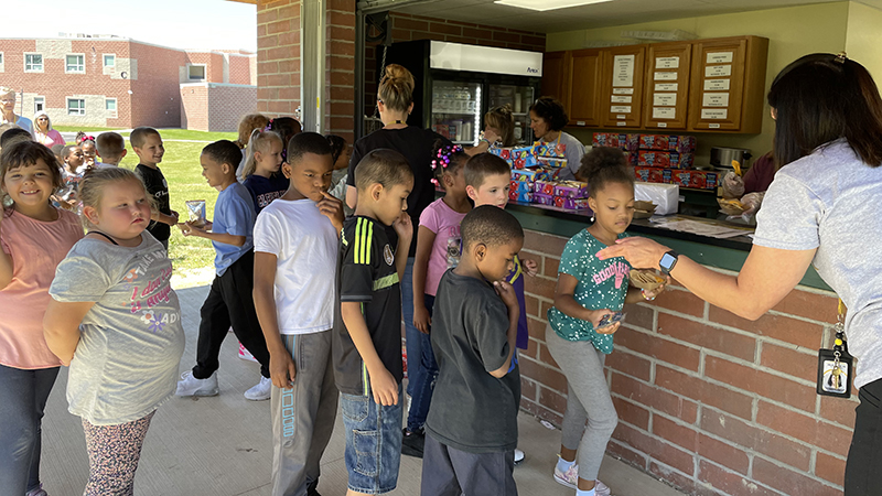 Students getting their nachos and juice from the concession stand.