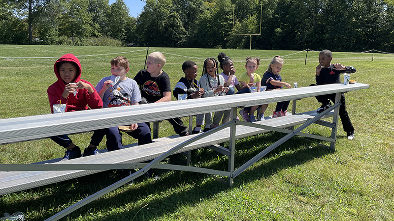 Students enjoy their nachos and juice.