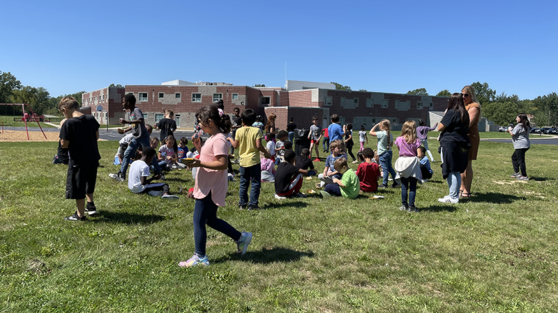 Students enjoy their nachos and juice together.