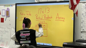 A fourth grader shows off her math skills for the group.