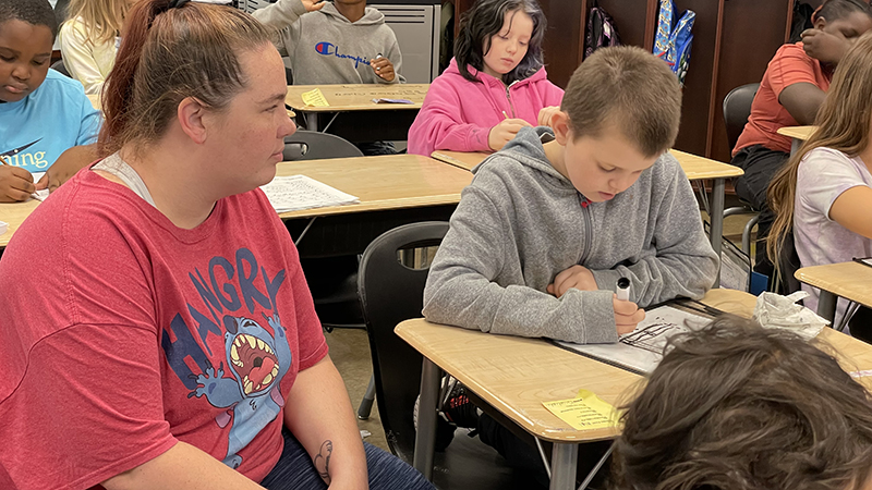 A student explains his math problem.