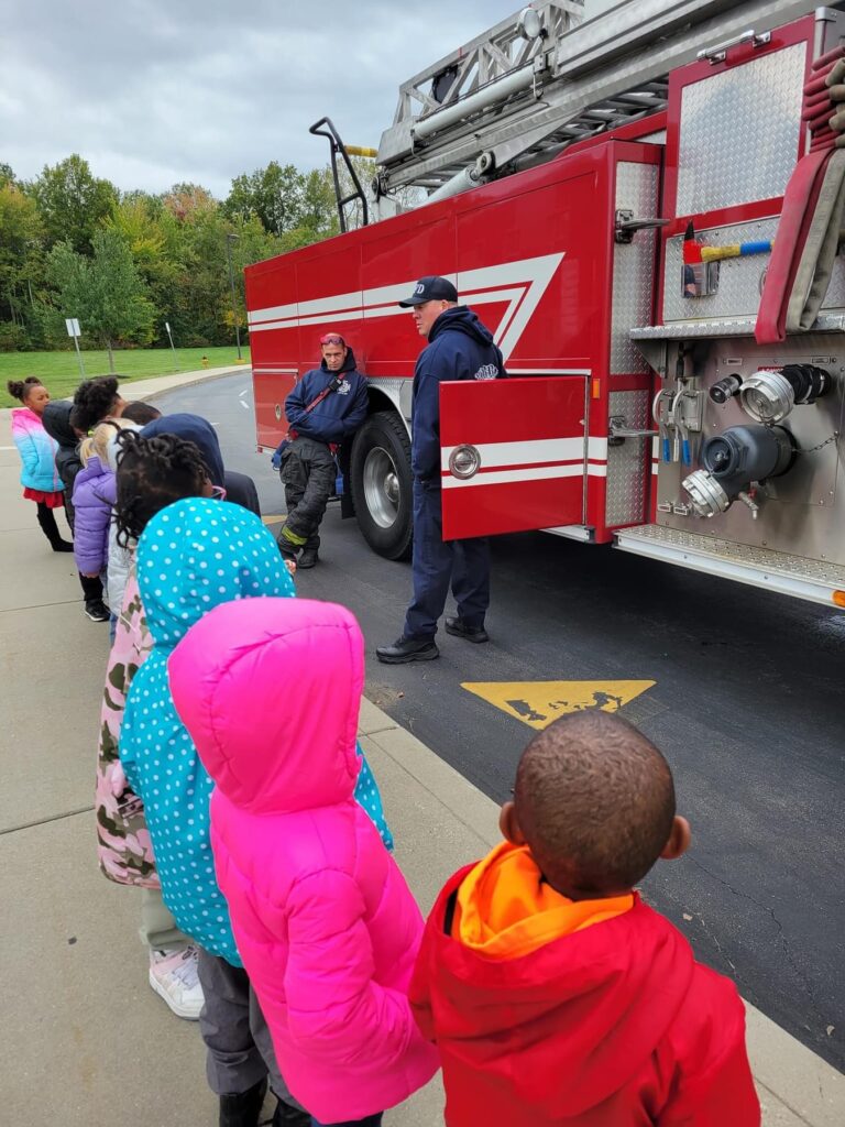 Students listen to fire safety information.