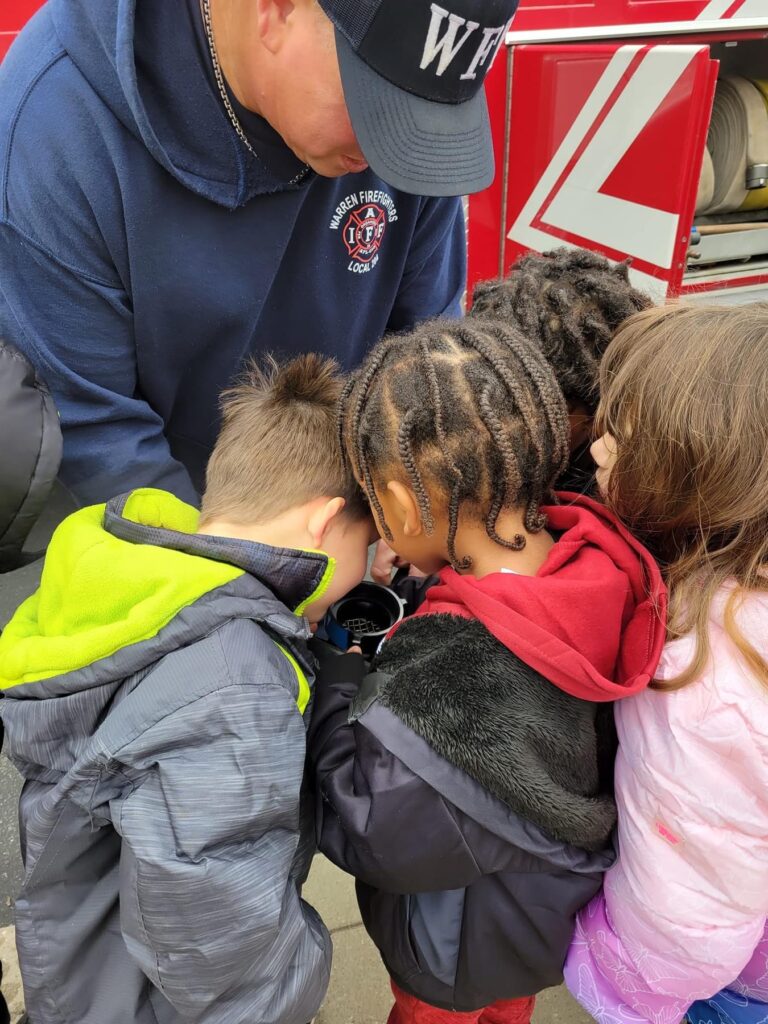 Students get a close up look at the end of a fire hose.