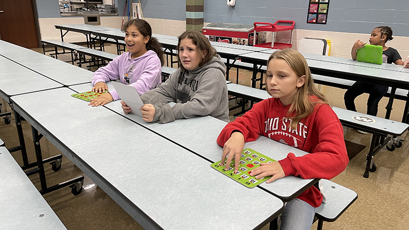 Students wait for the next number to be called.