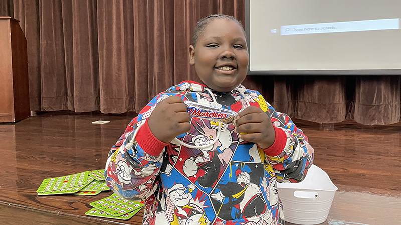 A student shows his bingo prize fior winning.